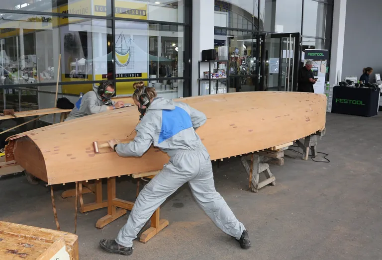Paul Winter und Clara B&ouml;ckenhoff arbeiten auf der Messe Interboot an der Jolle.
