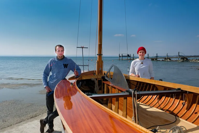 Paul Winter und Clara B&ouml;ckenhoff lehnen sich an die Jolle "Alte Liebe" 