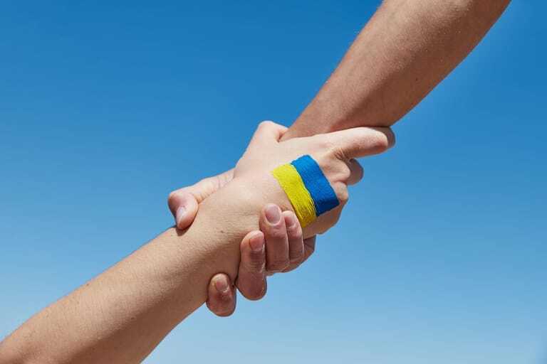 Hand mit ukrainischer Flagge