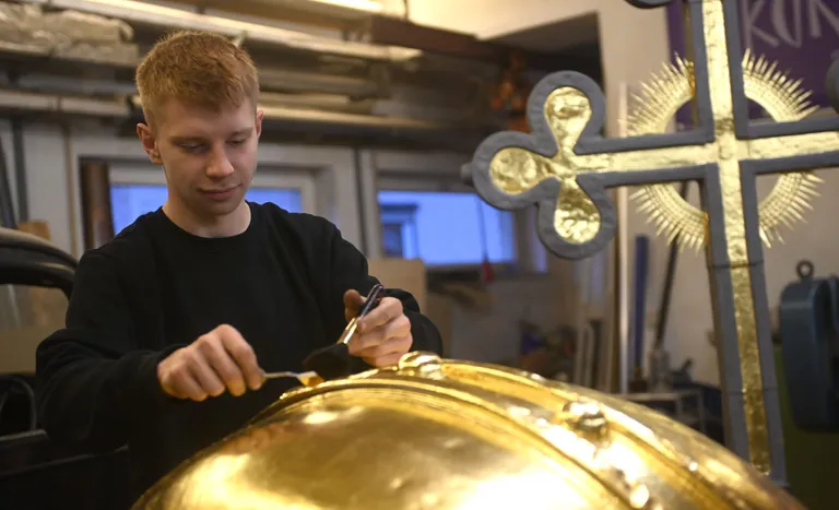 Til Blaurock legt Blattgold auf Kuppel