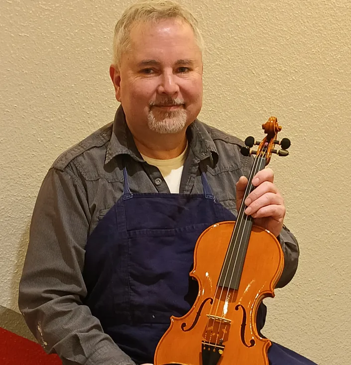 Geigenbaumeister Michael Wenzel mit der Wettbewerbs-Geige in seiner Werkstatt "Royal Violins" in Dresden.